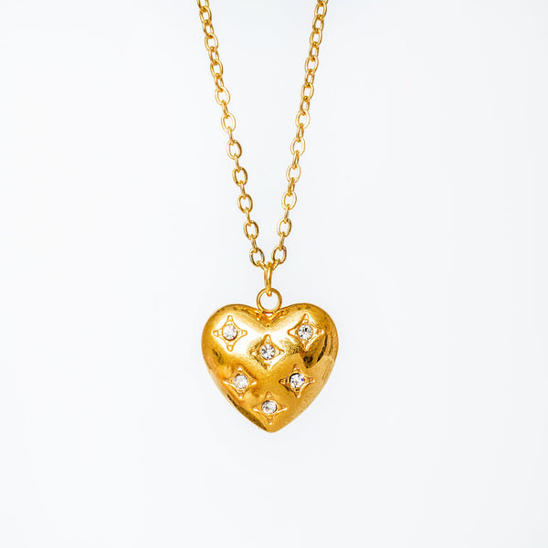 A gold-plated Amanda necklace with a heart-shaped pendant adorned with cubic zirconia gems.