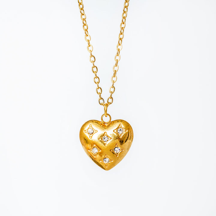 A gold-plated Amanda necklace with a heart-shaped pendant adorned with cubic zirconia gems.