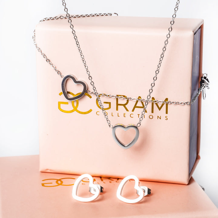 A gram collections's Amata Silver set placed on two uniquely designed pink boxes, standing the the center of the image 