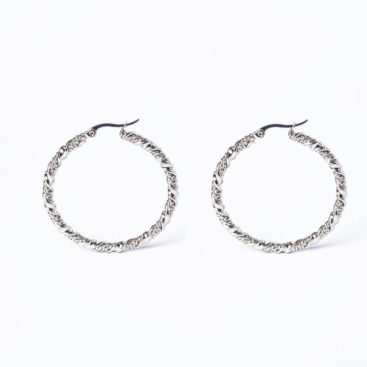 A close up view of amber earrings standing in the center of the image against a white background. 