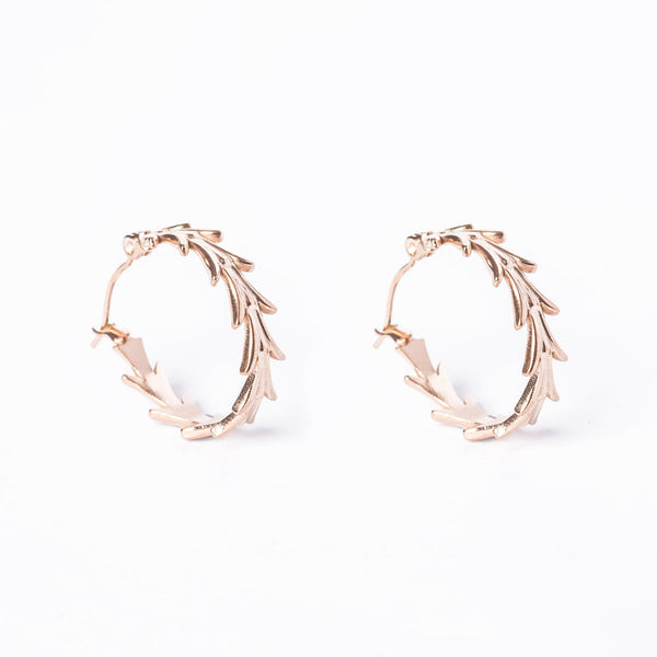 A pair of rose gold colored stainless steel Antonella hoop earrings with leaf patterns, displayed against a white background.