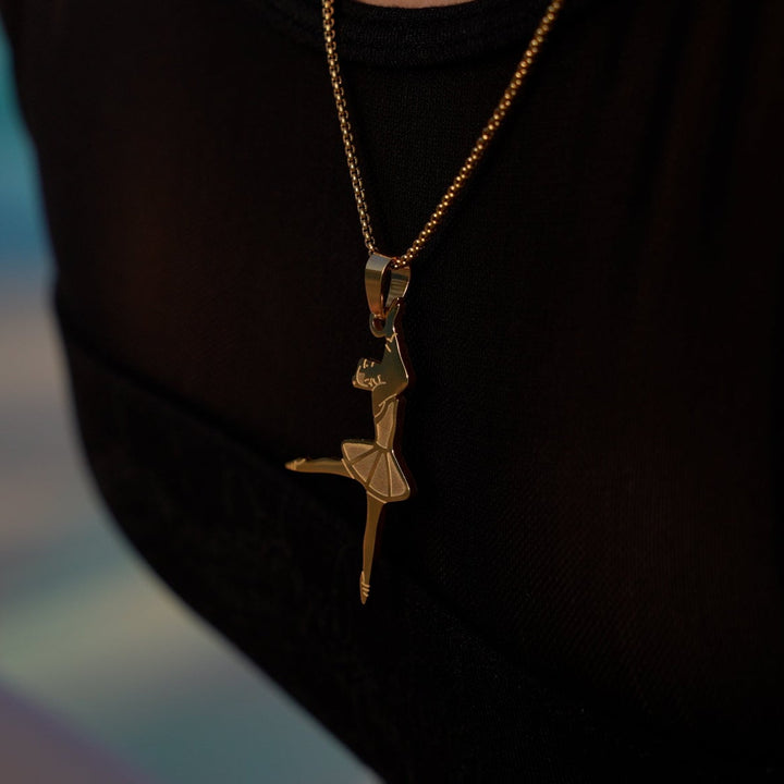 Ballerina wearing gram collections ballerina necklace combined with her black shirt. 
