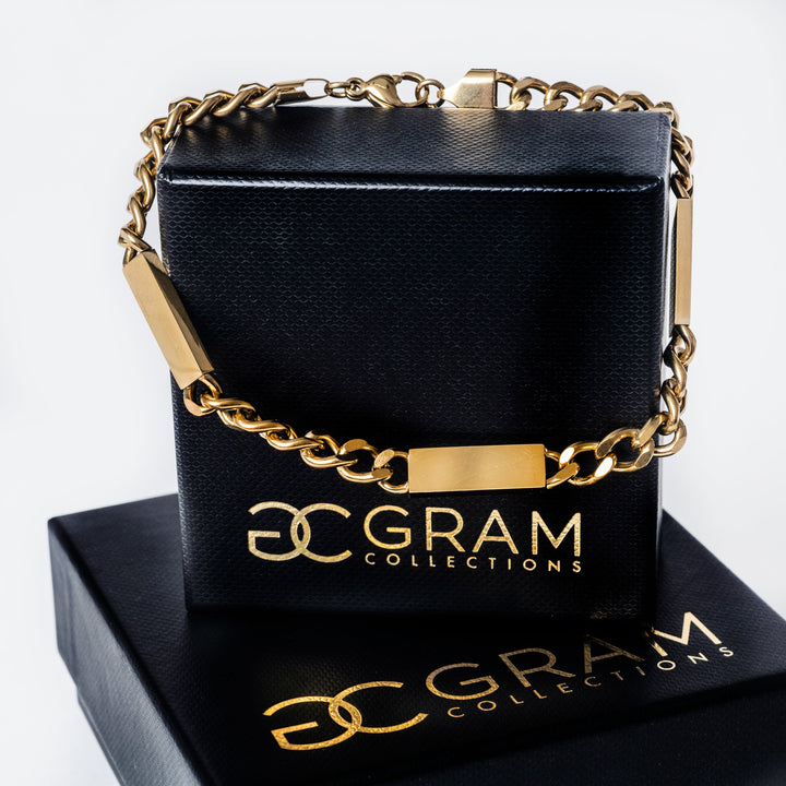 Bar Bracelet (Maltese Style) standing in the center of the image placed on its uniquely designed box. 