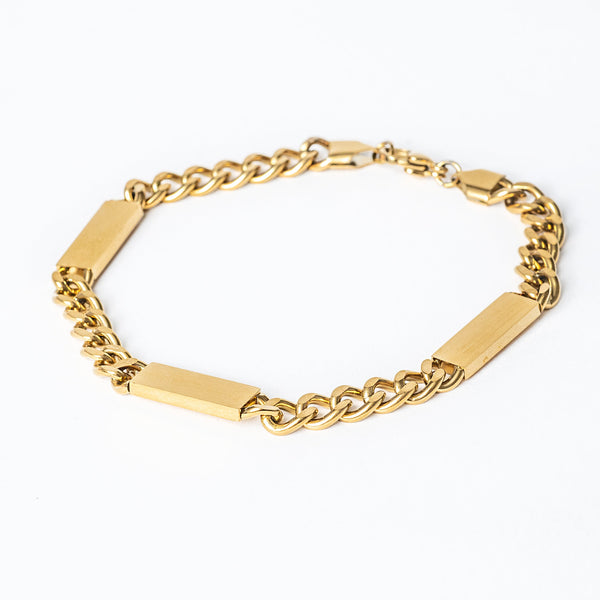 A close up view of stainless steel Bar bracelet with a Maltese cross style, featuring a chain link design and two rectangular tags.