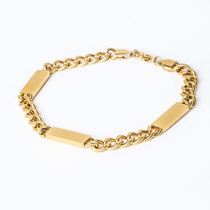 A close up view of stainless steel Bar bracelet with a Maltese cross style, featuring a chain link design and two rectangular tags.