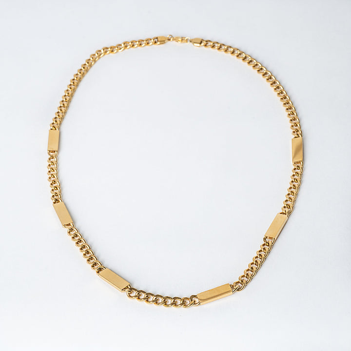 Bar Necklace Maltese style placed in the center of the image, seeing from a bird view. 