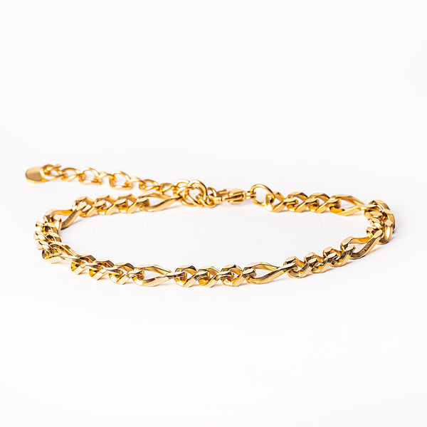 A bari gold bracelet placed in the center of the image against a white background 