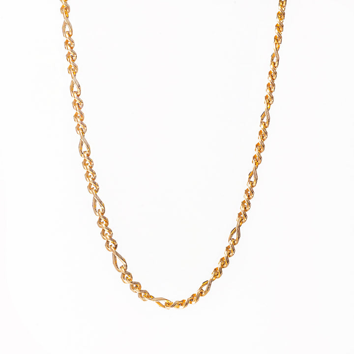 A close up view of necklace standing in the center of the image against a white background. 