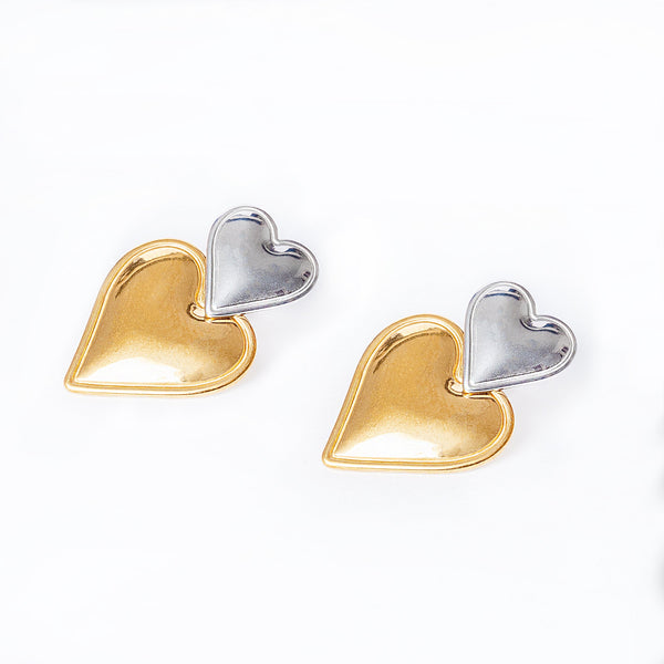 A pair of gold-plated stainless steel heart-shaped earrings on a white background.