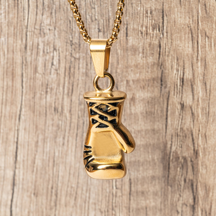 The Boxer Necklace standing in the center of the image against a wooden background. 