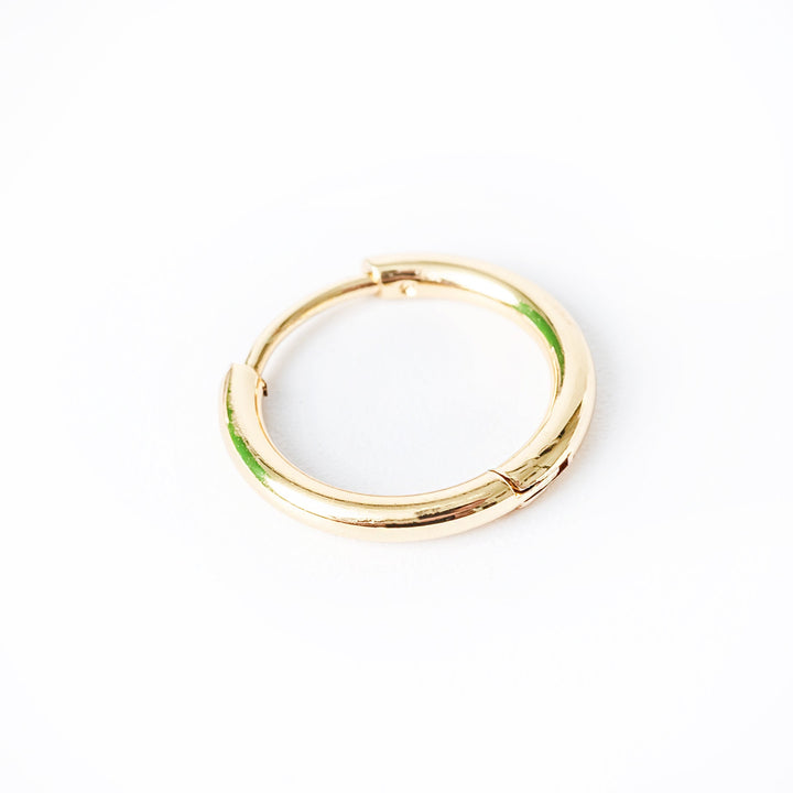 A single yellow gold-plated stainless steel Brandon hoop earring with a green tint on the surface.