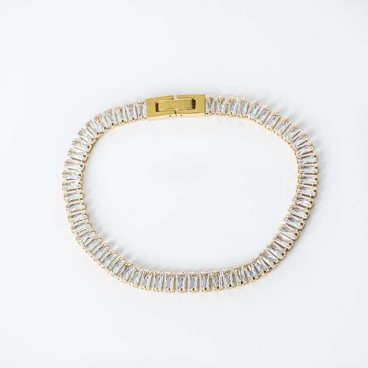 Gold Brooke bracelet featuring rectangular clear gemstones set along the entire band.