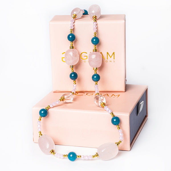 A Bubblegum Necklace necklace placed on its box, standing in the center of the image against a white background. 