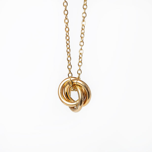 A yellow gold-plated stainless steel necklace with a geometric pendant.