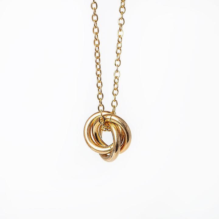 A yellow gold-plated stainless steel necklace with a geometric pendant.