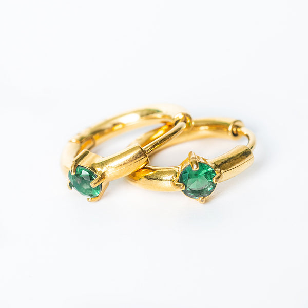Gold Catalina Earrings featuring vivid green gemstones in a circular hoop design.