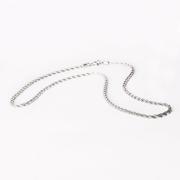 A silver stainless steel necklace with a geometric pattern, displayed against a white background.