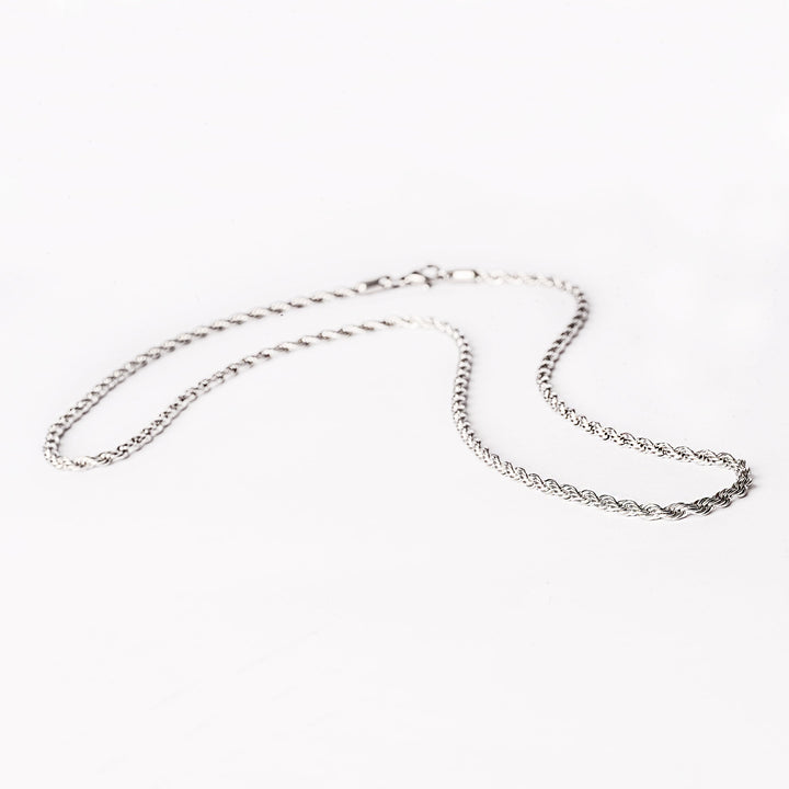 A silver stainless steel necklace with a geometric pattern, displayed against a white background.