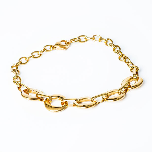 A Chantelle Gold Bracelet close up view standing in the center of the image against a white background. 
