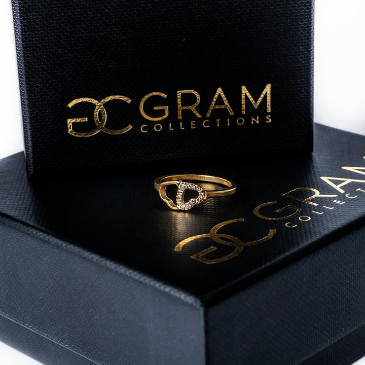 Chloe Gold Ring placed on its box, standing in the center of the image against a white background. 