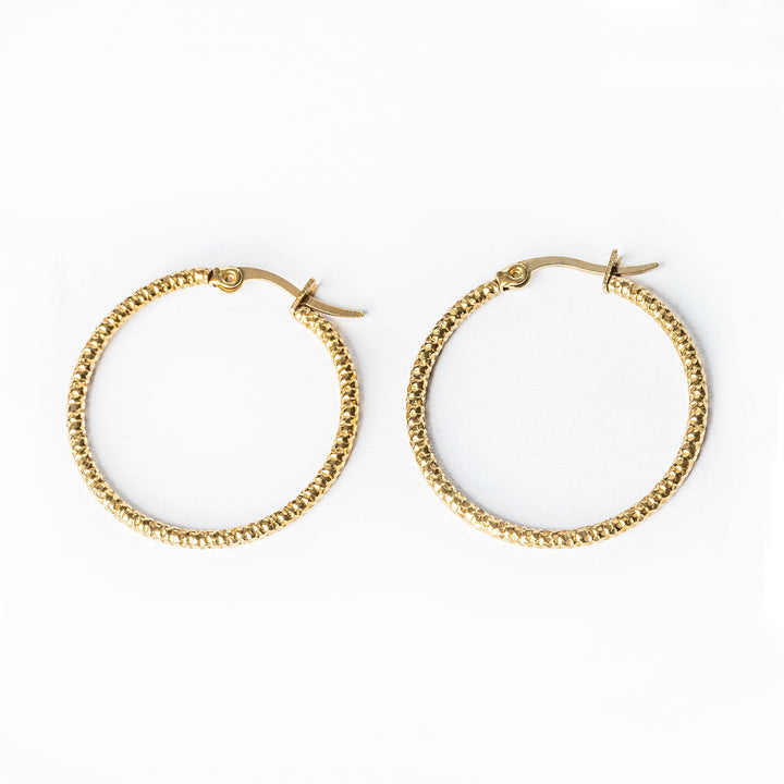 A close up view of Claudia Earrings standing in the center of the image. 