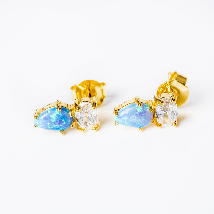 A close up view of clement earrings standing in the center of the image against a white background. 