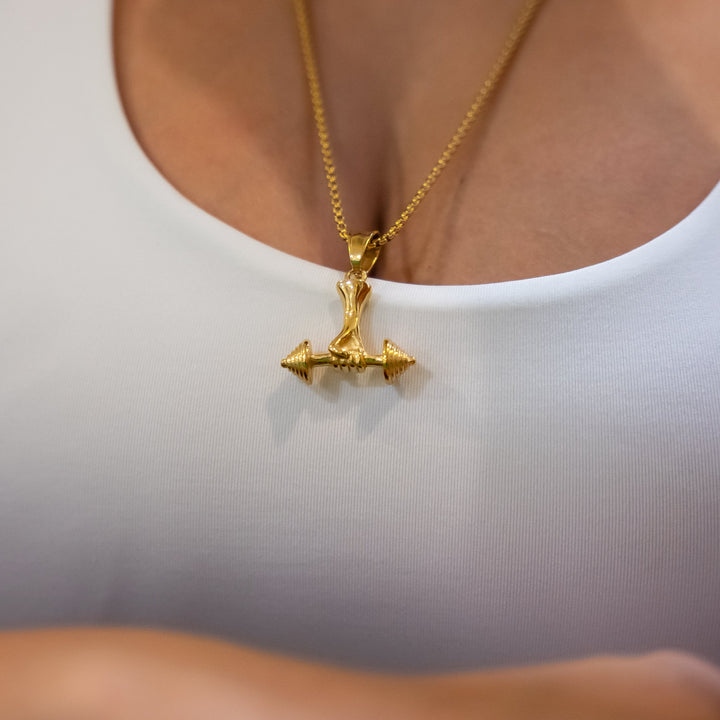 A close up view of a woman wearing the power necklace and white t-shirt. 