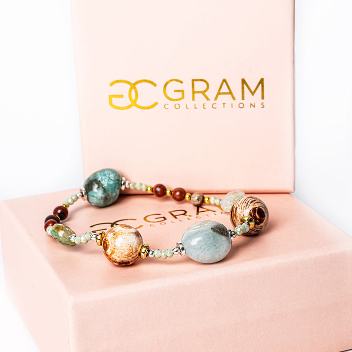 a gram collections Clover Bracelet standing in the center of the image, placed on its box, surrounded by a white background. 