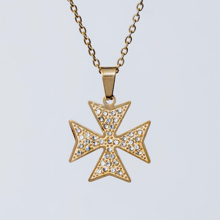 A close up view of Cross  of the order Necklace and pendant standing in the center of the image against a white background. 