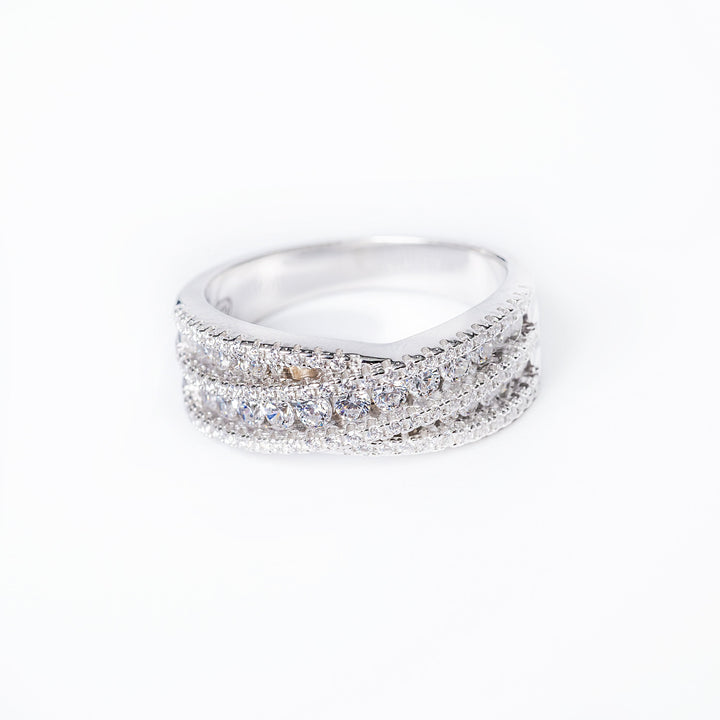 a close up view of a cynthia ring, standing in the center of the image, against a white background. 