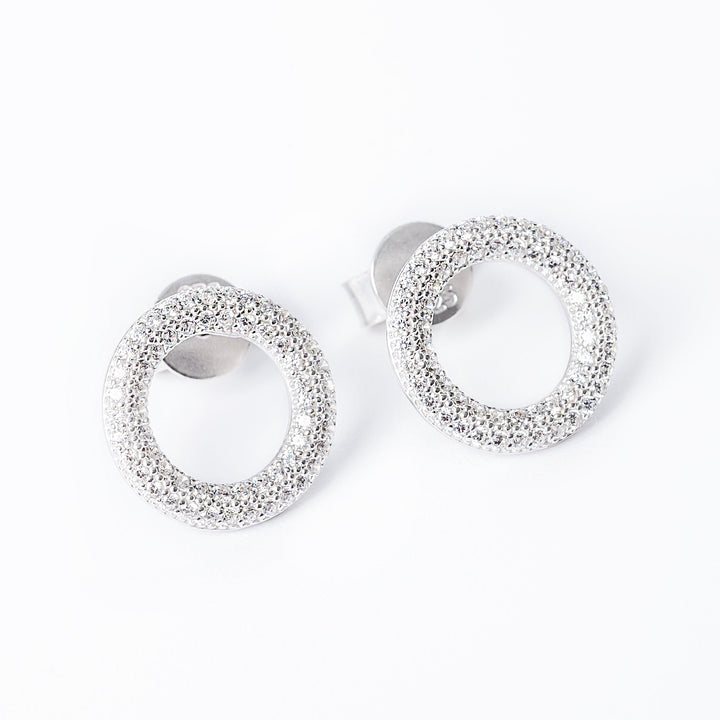 A close up view of Dalphine earrings standing against a white background. 