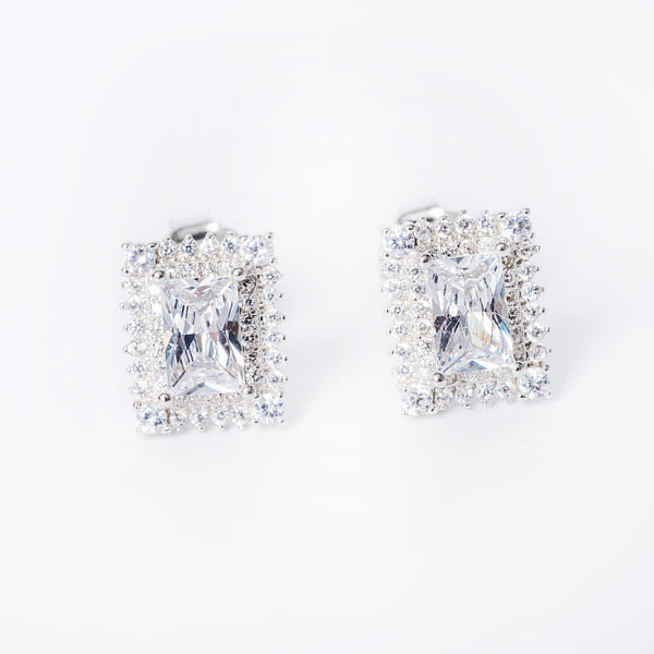 A pair of sterling silver Daphne earrings with a cubic zirconia gemstone in a classic six-prong setting.