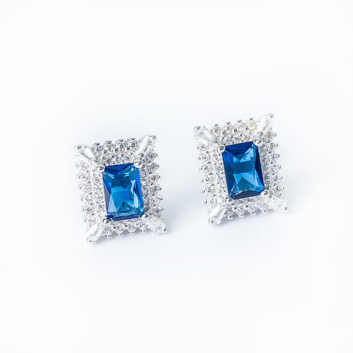 A close up profile view of Diana earrings standing against a white background. 