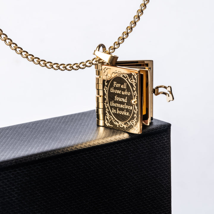 The educational necklace standing in the corner of its black box. 