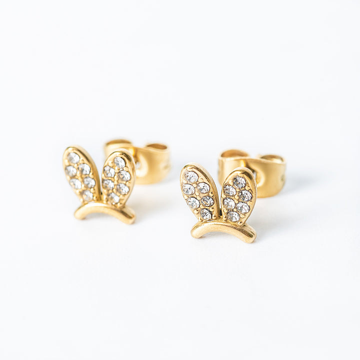 Gold Elena stud earrings with crystal-studded bunny-shaped design shown from a side angle.