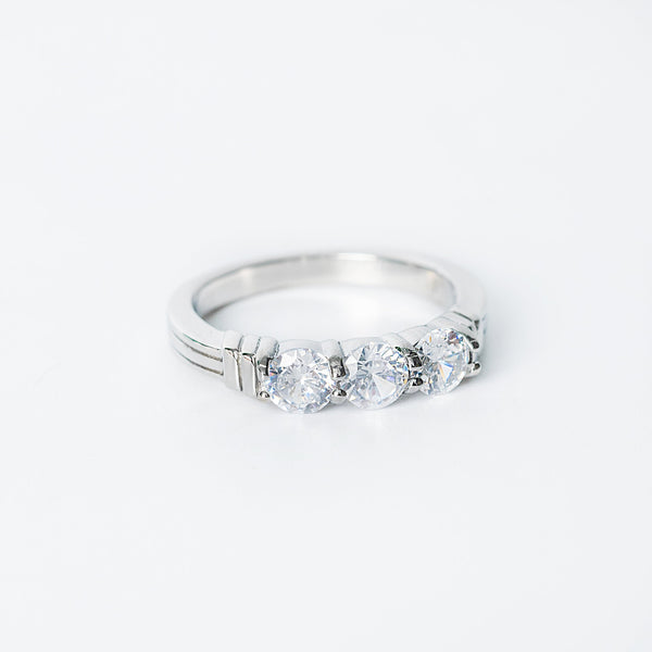 Silver Ellie ring featuring three round clear gemstones set in a row.