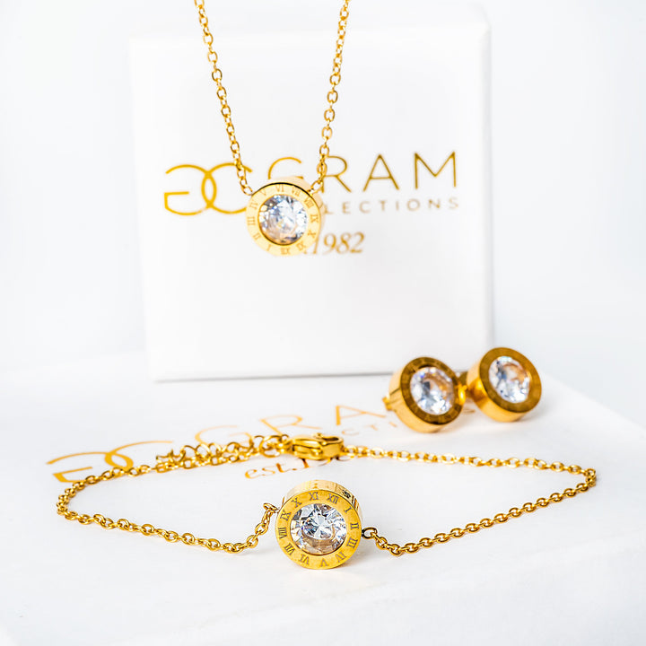 Easter gold necklace standing in the center of the image, and in front of its box. 