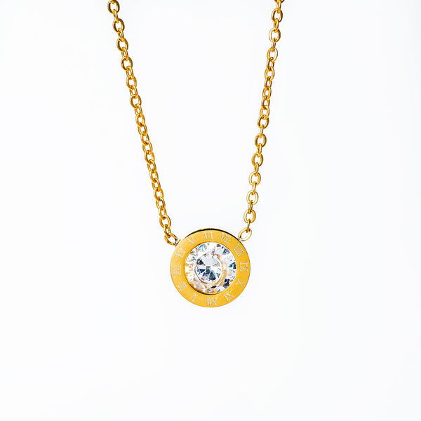 A yellow gold-plated stainless steel Easter necklace with a round pendant featuring a cubic zirconia gemstone.