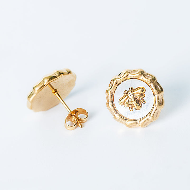Gold Evelyn bee stud earrings displayed on a white background