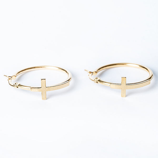 A close up view of Fabia Earrings standing in the center of the image. 
