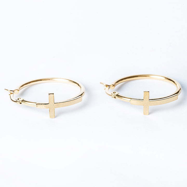 A close up view of Fabia Earrings standing in the center of the image. 