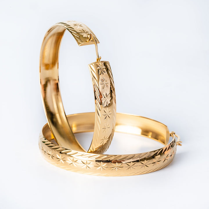 A close up view of Fili Earrings Maltese style standing in the center of the image against a white background. 