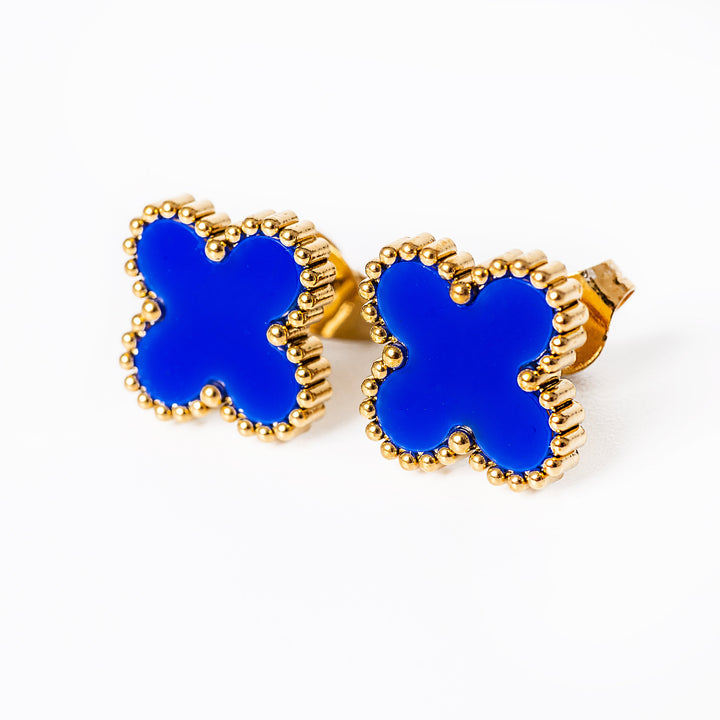 A close up view of Fiore Earrings  in a blue colour standing in the center of the image against a white background. 