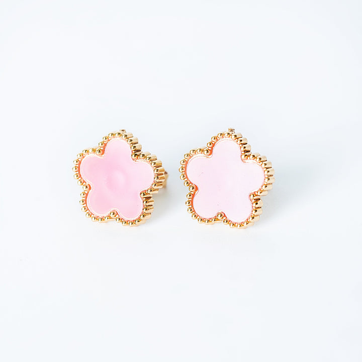 Gold Fiore stud earrings shown as a pair with soft pink flower-shaped fronts on a white background