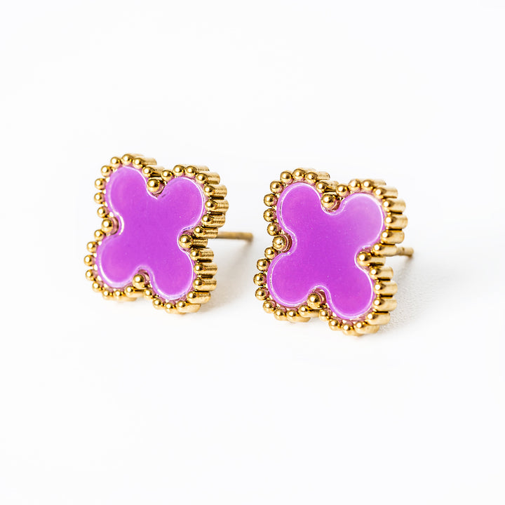 A close up view of Fiore Earrings  in pink colour standing in the center of the image against a white background. 