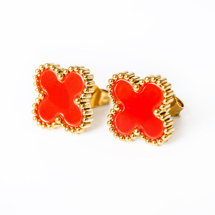 A close up view of Fiore Earrings in red colour standing in the center of the image against a white background. 
