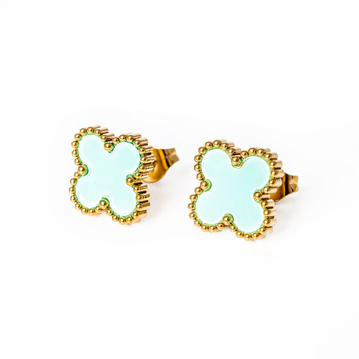 A close up view of fiore earrings standing in the center of the image. 