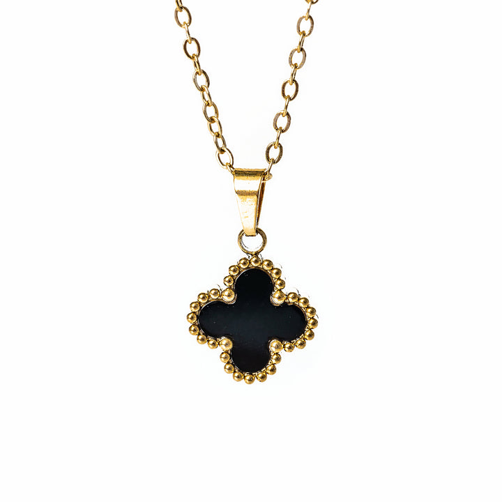 A close up view of Fiore necklace with black pendant, standing in the center of the image against a white background