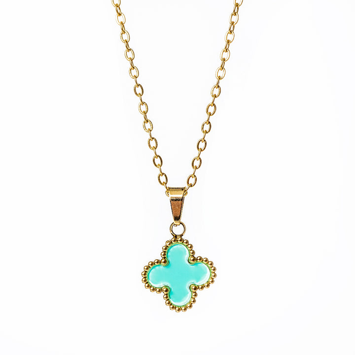 A close up view of Fiore necklace with green pendant, standing in the center of the image against a white background. 