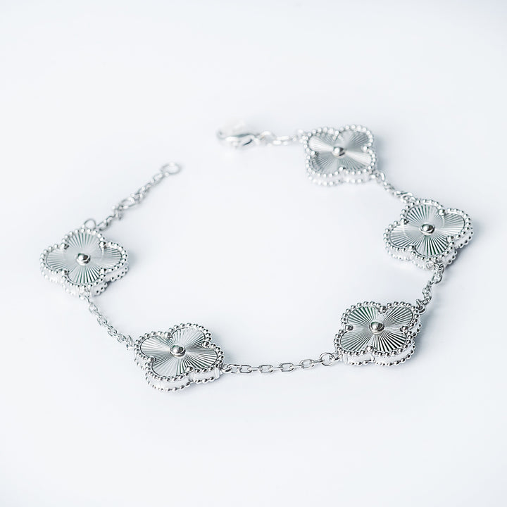 Silver Fiorella bracelet with multiple flower-shaped links shown in a close-up on a white background